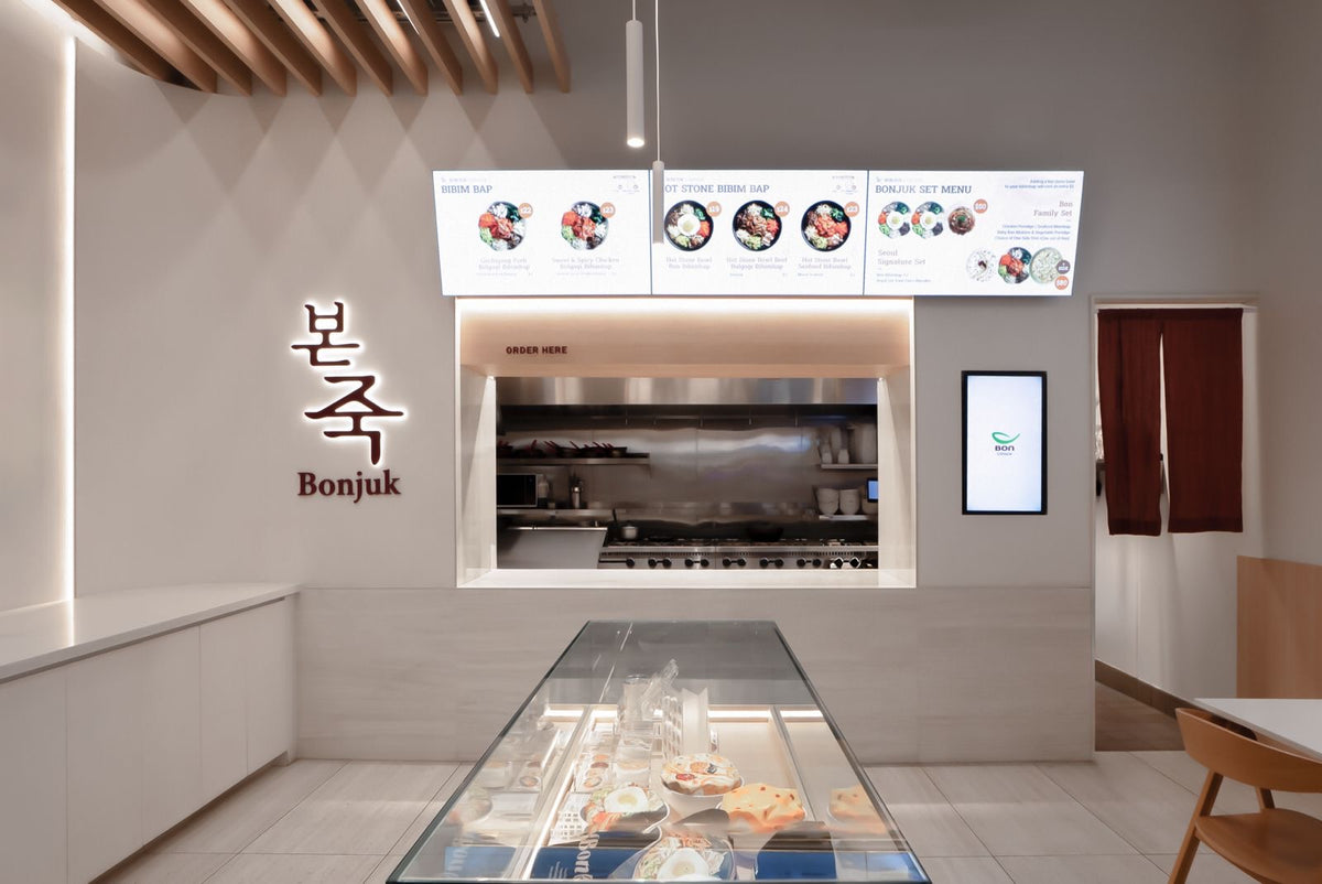 Bonjuk service counter with menu boards and refrigerated display case