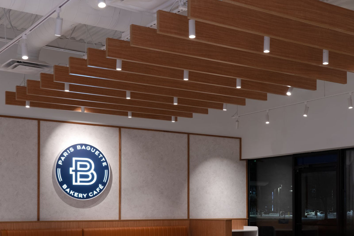 Paris Baguette interior with slatted wood ceiling and track lighting